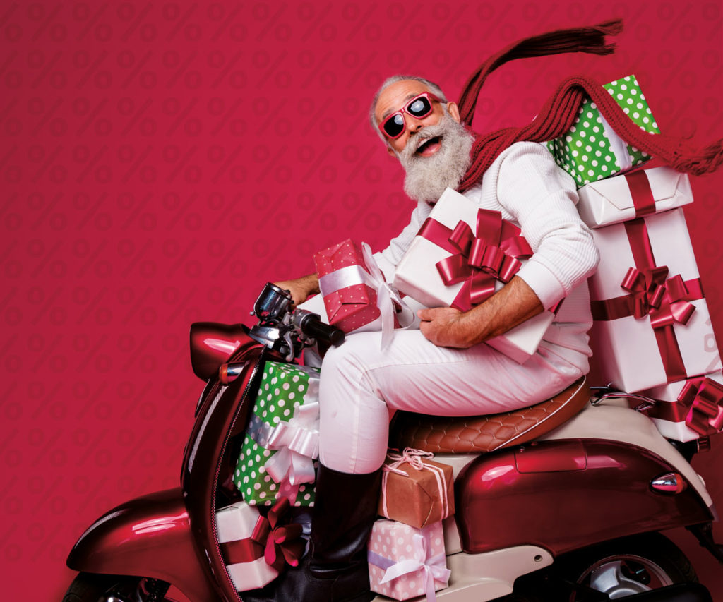 Weihnachtsmann auf Moped für Rabattaktion im Gutscheinshop